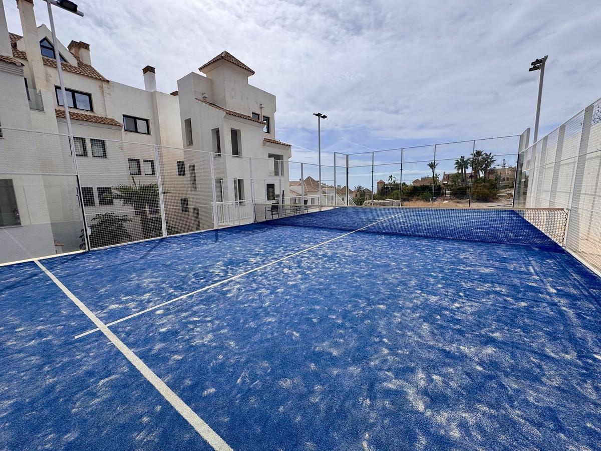 Ground-floor apartment with private garden, sea views, and luxury amenities in Benalmádena.